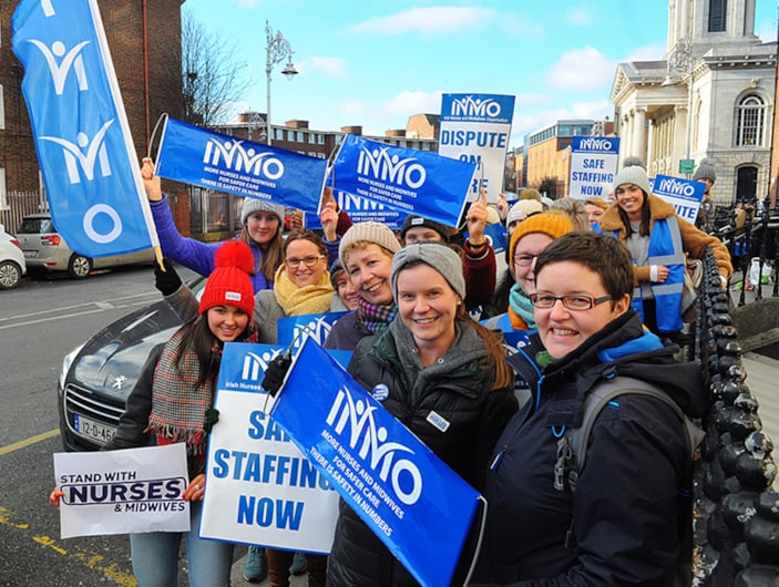 INMO members on picket line holding INMO glags and banners